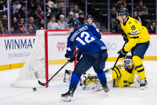 Joona Saarelainen of Finland against goaltender Love