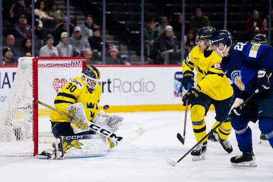 Emil Hemming of Finland against goaltender Love Härenstam
