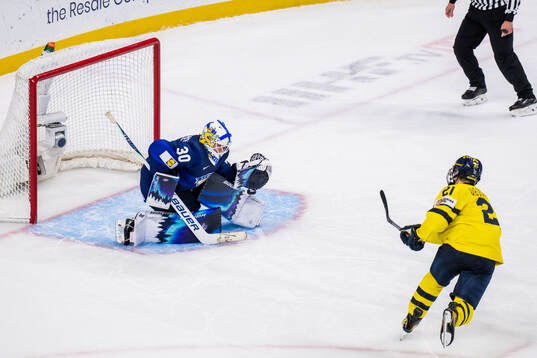Goaltender Petteri Rimpinen of Finland saves against Viggo