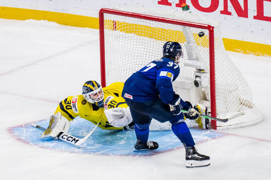 Matias Vanhanen of Finland scores against goaltender Love