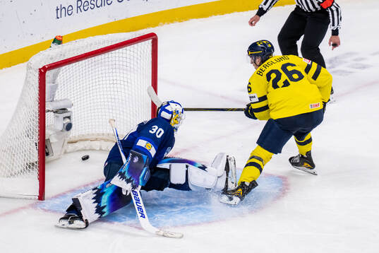 Jack Berglund of Sweden scores against goaltender Petteri