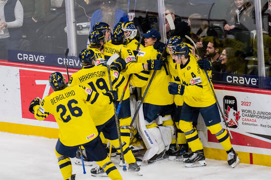 Players of Sweden celebrate with goaltender Love Härenstam
