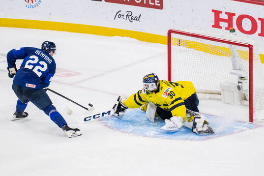 Emil Hemming of Finland and goaltender Love Härenstam of