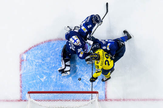Casper Juustovaara Karlsson of Sweden challenges goaltender
