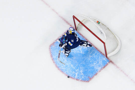 Goaltender Petteri Rimpinen of Finland hits his stick in