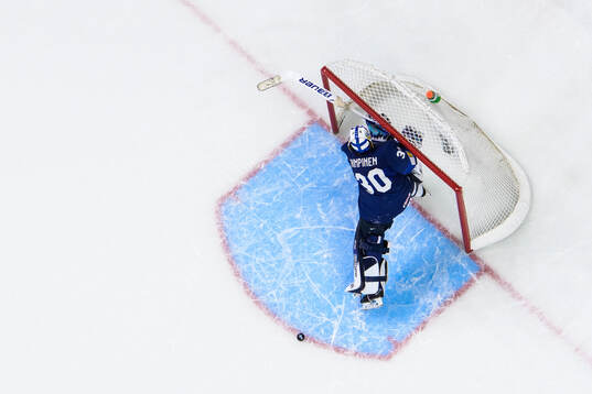 Goaltender Petteri Rimpinen of Finland hits his stick in