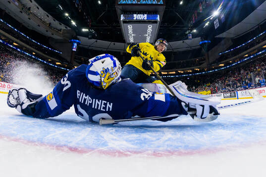 Goaltender Petteri Rimpinen of Finland saves a shot from