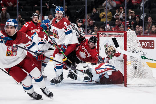 Cole Reschny of Canada and goaltender Michal Orsulak of