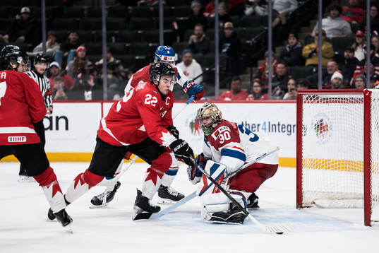 Porter Martone of Canada and goaltender Michal Orsulak of