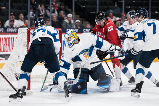 Goaltender Petteri Rimpinen of Finland and Cole Beaudoin of