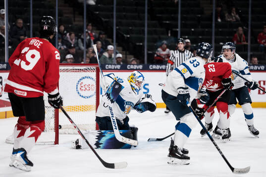 Goaltender Petteri Rimpinen of Finland lets in the 3-2 goal