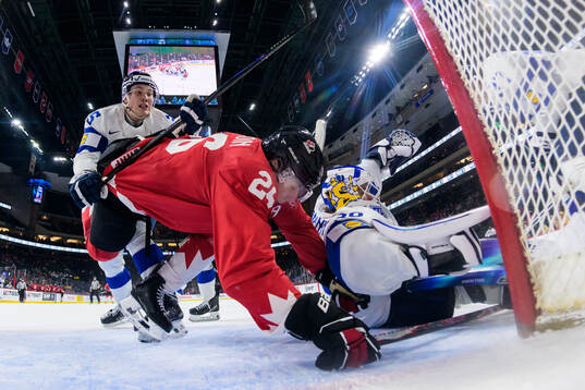 Lasse Boelius and goaltender Petteri Rimpinen of Finland in
