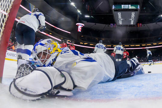 Goaltender Petteri Rimpinen of Finland looks dejected