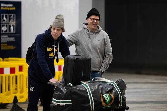 Måns Goos is met by his father Peter Goos as he arrives at