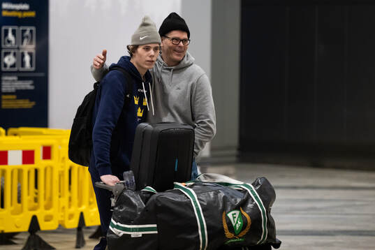 Måns Goos is met by his father Peter Goos as he arrives at