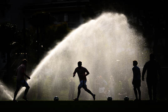 General view of a player infront of a sprinkler