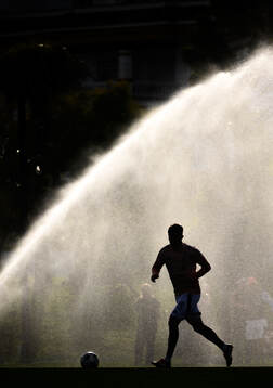General view of a player infront of a sprinkler