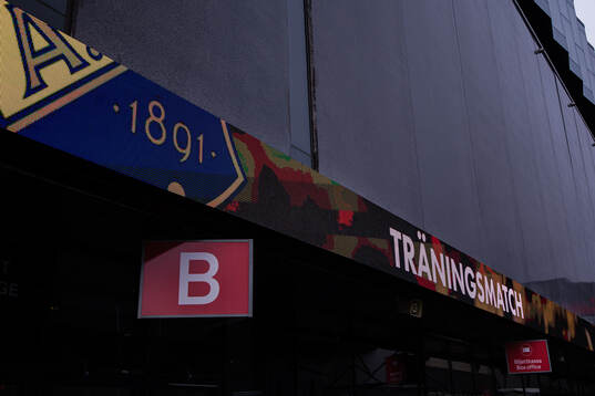 En ljusskylt på Strawberry Arena annonserar om