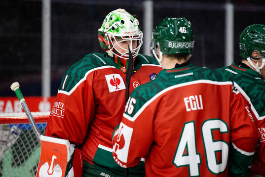 Goaltender Lars Johansson and Dominik Egli celebrate