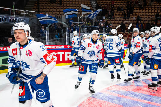 Livio Stadler of EV Zug and team mates looks dejected