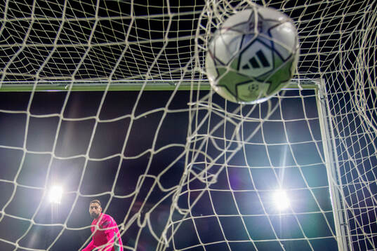 Goalkeeper Gianluigi Donnarumma of Manchester City lets in