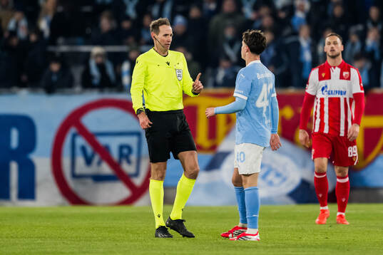 Referee Sascha Stegemann and Kenan Busuladzic of Malmö FF