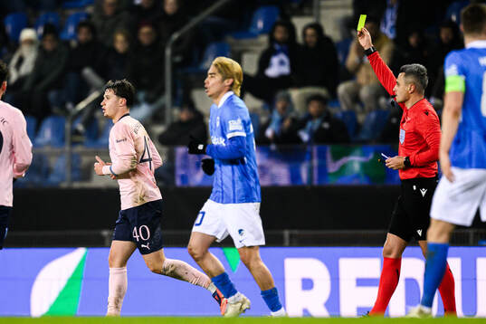 Kenan Busuladzic of Malmö FF receives a yellow card from