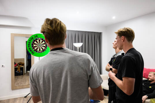 August Wängberg, Robin Frej och Lucas Hedlund spelar dart