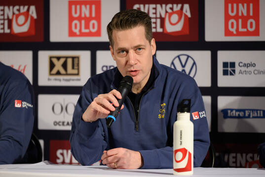 Head coach Sam Hallam at a press conference with the