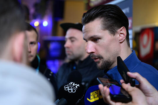 Erik Karlsson is interviewed at a press conference with the