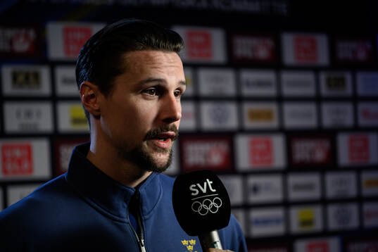 Erik Karlsson is interviewed at a press conference with the