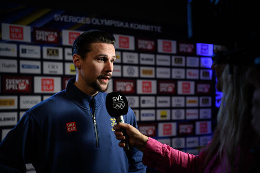 Erik Karlsson is interviewed at a press conference with the