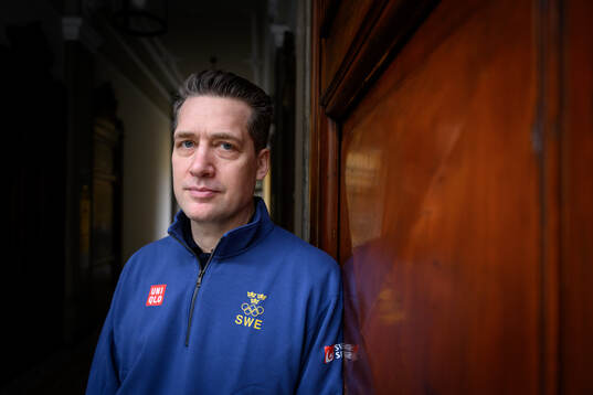 Head coach Sam Hallam poses for a portrait at a press