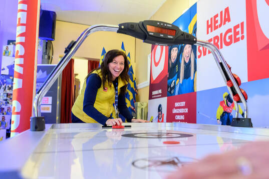Sara Gottfarb playing air hockey at Sweden Arena