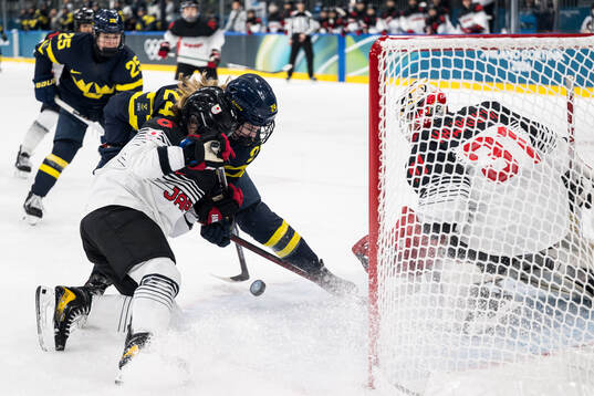 Kohane Sato and goaltender Riko Kawaguchi of Japan and Ebba