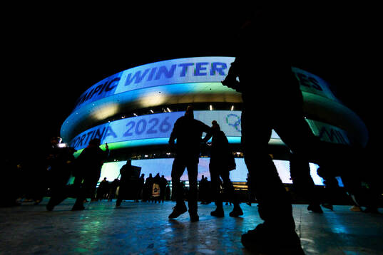Spectators outside of Milano Santagiulia Ice Hockey Arena