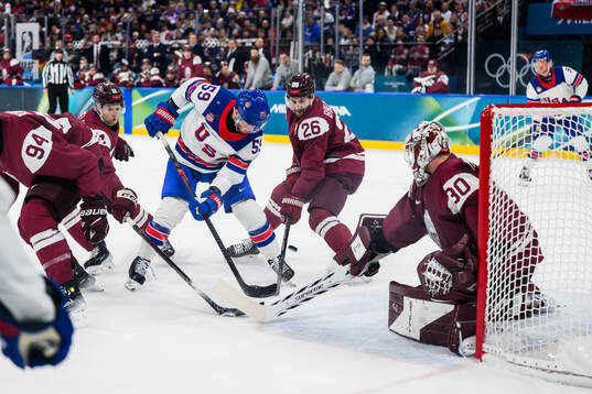 Jake Guentzel of USA against Uvis Janis Balinskis and