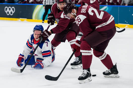 Brady Tkachuk of USA against Roberts Mamcics and Uvis Janis