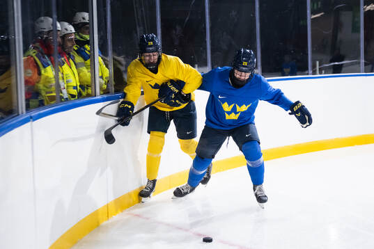 Thea Johansson and Lina Ljungblom of Sweden at a ice hockey