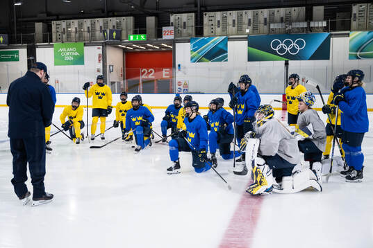 Players of Sweden gather at a ice hockey practice session