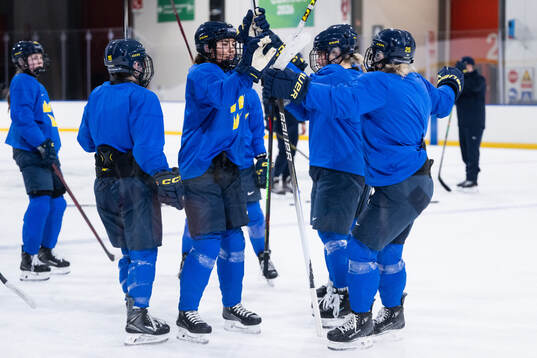 Anna Kjellbin and Lina Ljungblom of Sweden at a ice hockey