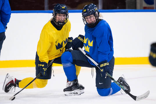 Mira Hallin and Lina Ljungblom of Sweden at a ice hockey