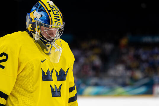 Goaltender Filip Gustavsson of Sweden looks dejected in the