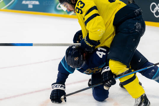 Mika Zibanejad of Sweden and Miro Heiskanen of Finland in