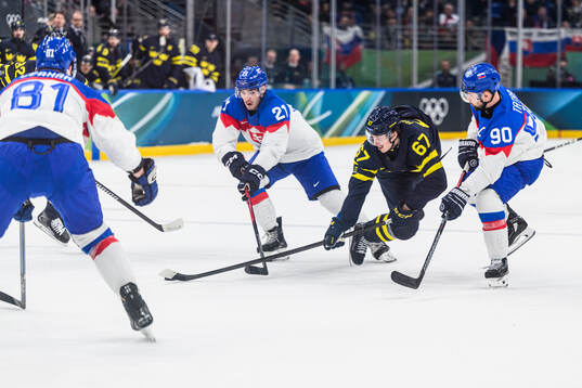 Adam Ruzicka and Tomas Tatar of Slovakia and Rickard Rakell