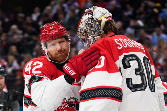 Phillip Bruggisser and goaltender Mads Søgaard of Denmark