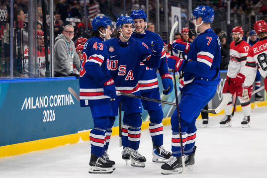 Jack Hughes celebrate with Quinn Hughes and Brady Tkachuk