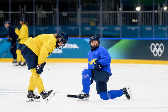 Hanna Olsson and Anna Kjellbin of Sweden at an ice hockey