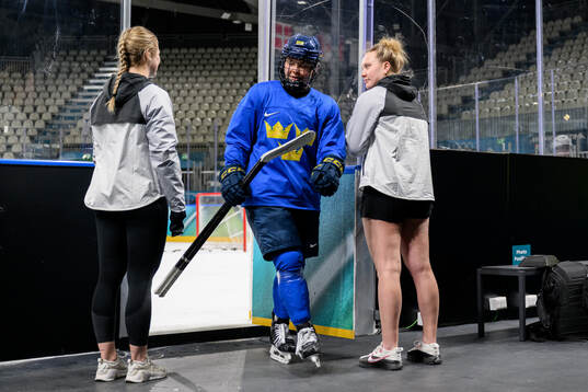 Nicole Hall and Jenna Raunio of Sweden at an ice hockey