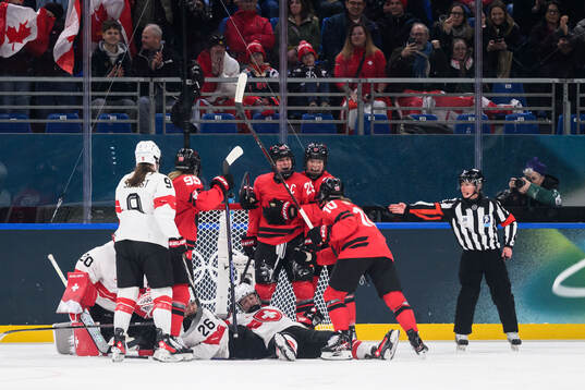 Marie-Philip Poulin of Canada celebrate with Daryl Watts,